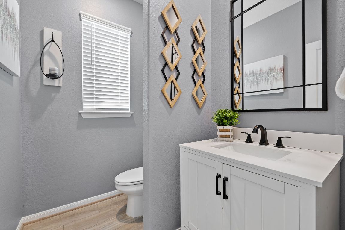 408 Ravello Street Liberty Hill, TX 78642 - Photo 22 of 40 a bathroom with a toilet sink and mirror