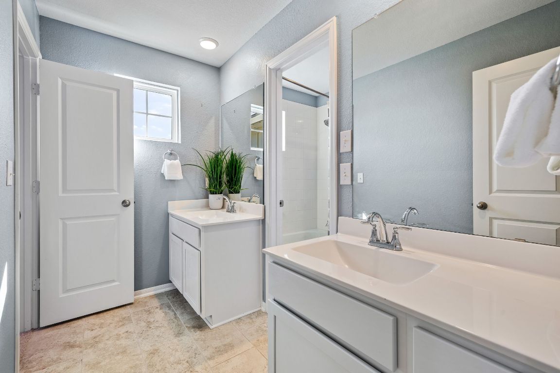 408 Ravello Street Liberty Hill, TX 78642 - Photo 24 of 40 a bathroom with a sink and a mirror