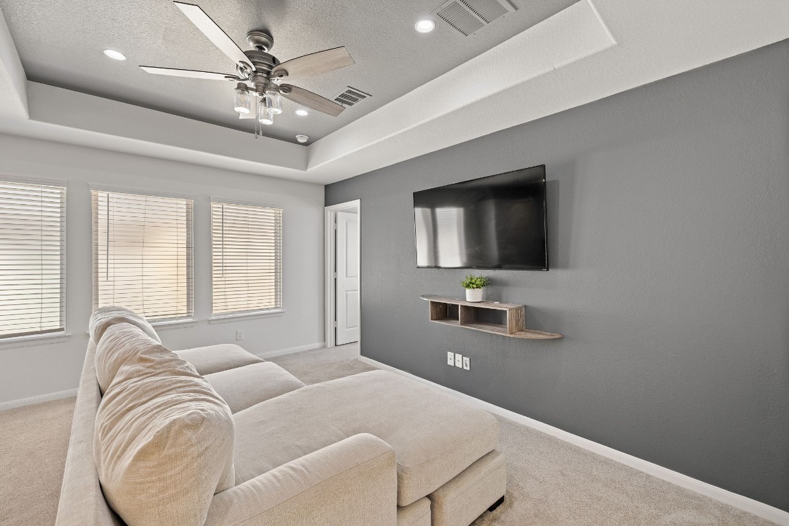 408 Ravello Street Liberty Hill, TX 78642 - Photo 30 of 40 a living room with furniture and a flat screen tv