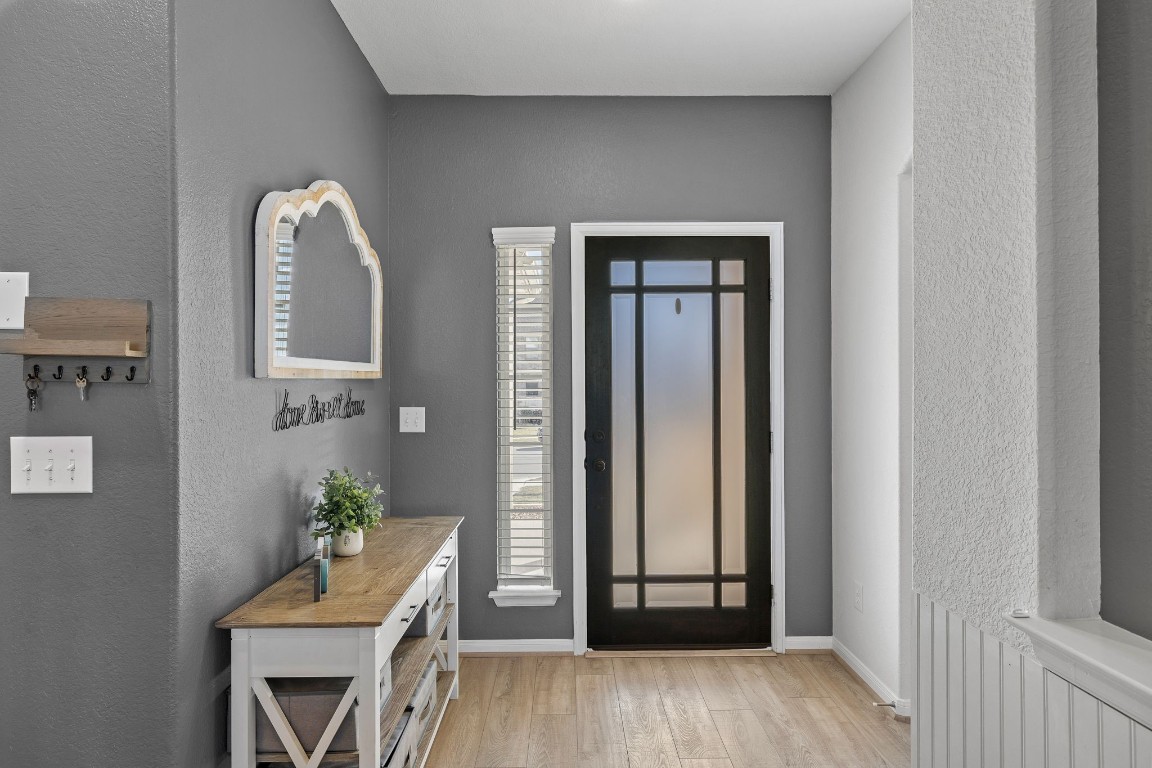 408 Ravello Street Liberty Hill, TX 78642 - Photo 3 of 40 a view of an entryway with wooden floor