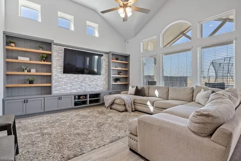 a living room with fireplace furniture and a flat screen tv