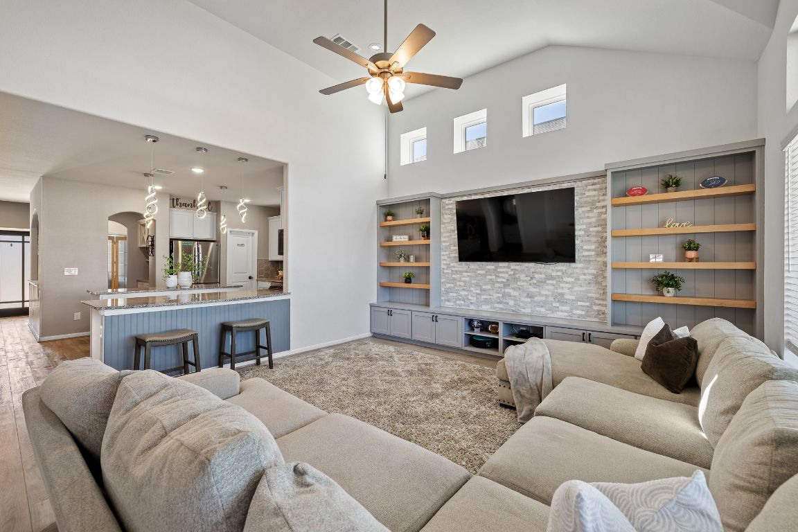408 Ravello Street Liberty Hill, TX 78642 - Photo 7 of 40 a living room with furniture kitchen view and a flat screen tv
