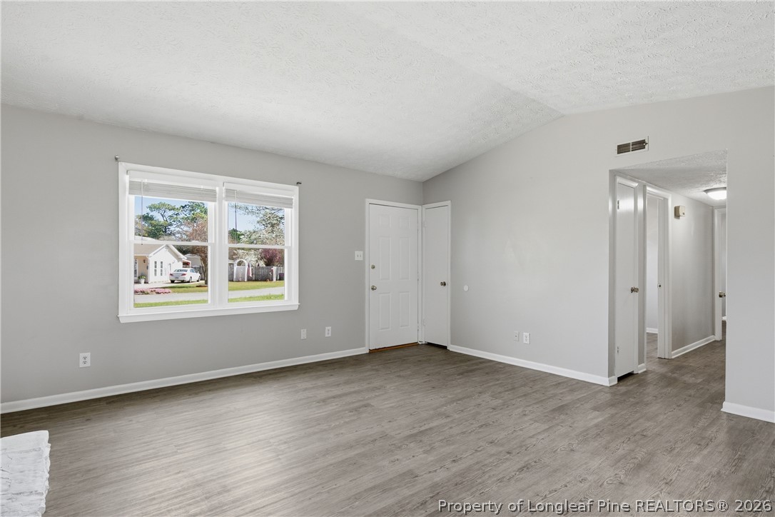 6319 Rustic Ridge Hope Mills, NC 28348 - Photo 9 of 39 a view of an empty room with wooden floor and a window
