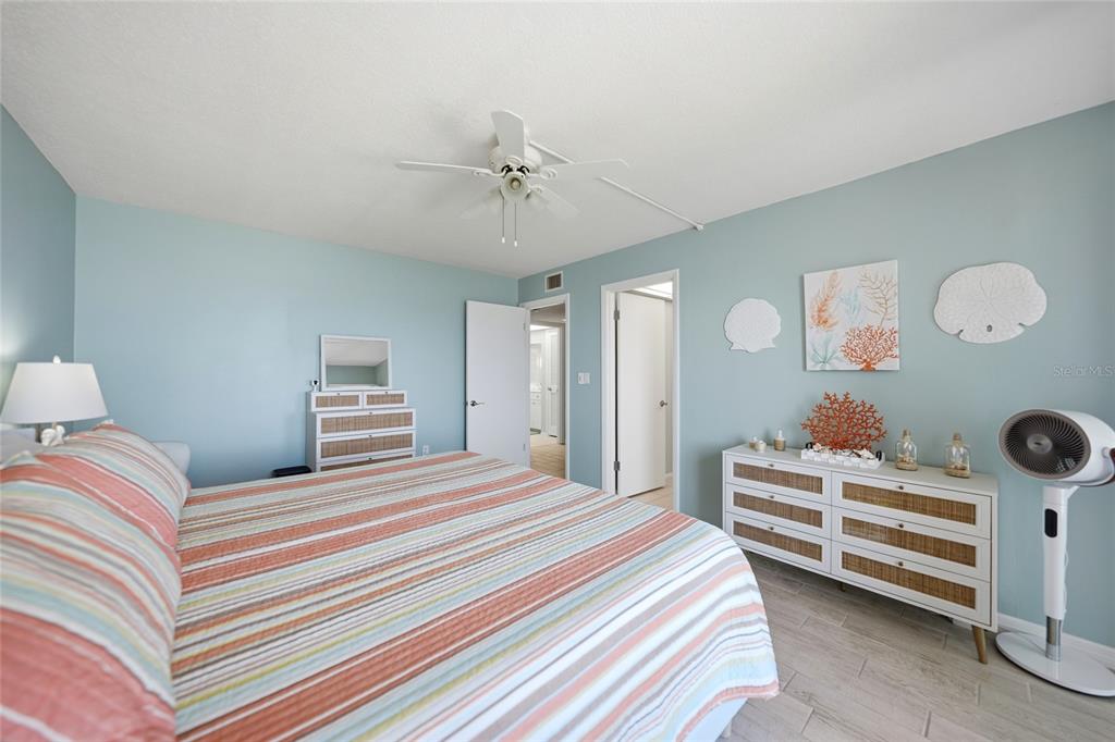 1 Colony Point Drive, Unit A10 Punta Gorda, FL 33950 - Photo 17 of 31 a bedroom with a bed and a chandelier