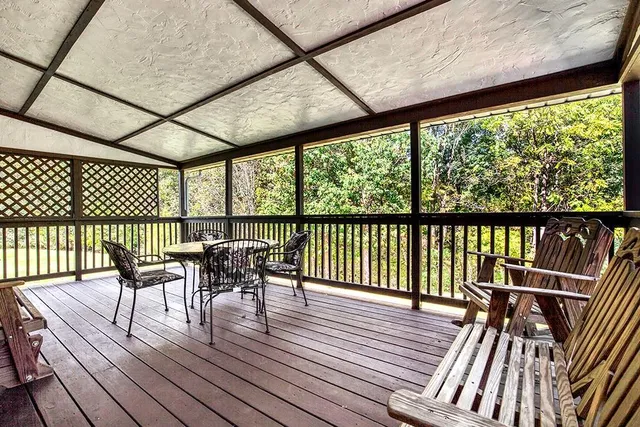 a view of a deck with wooden floor and outdoor seating