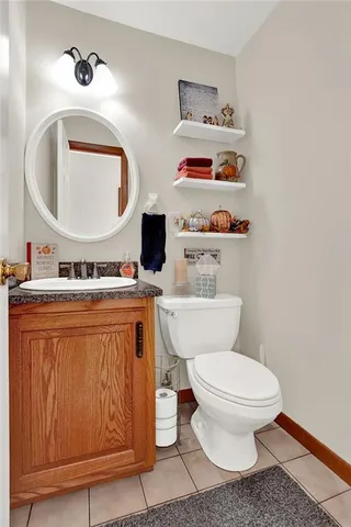 a bathroom with a toilet a sink and a mirror
