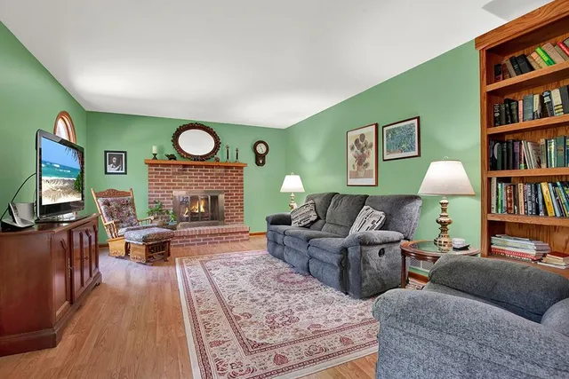 a living room with furniture and a bookshelf