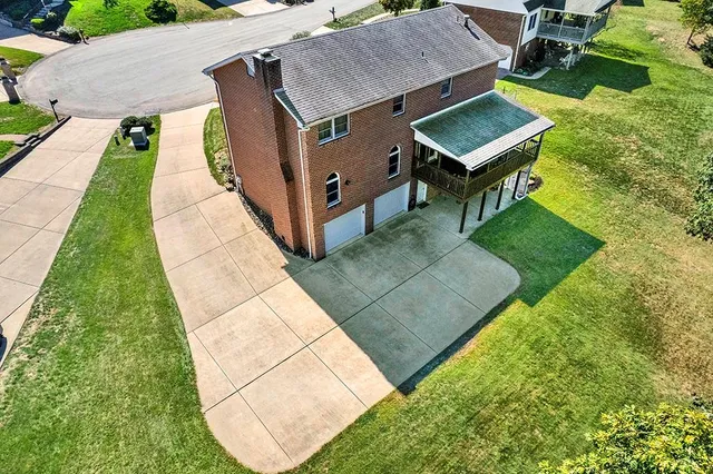 an aerial view of a house with swimming pool and sitting area