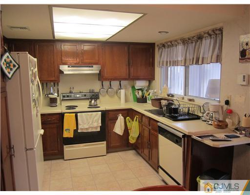 35 Haddon Road Monroe Township, NJ 08831 - Photo 4 of 6 a kitchen with stainless steel appliances granite countertop a sink stove and refrigerator