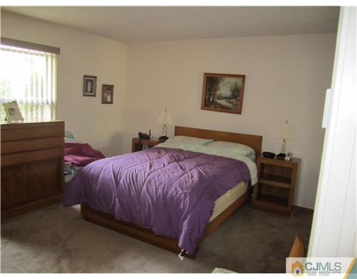 35 Haddon Road Monroe Township, NJ 08831 - Photo 6 of 6 a bedroom with a bed and a dresser