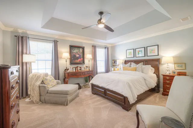 a spacious bedroom with a bed and glass windows