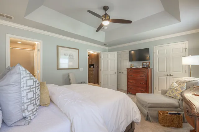 a bedroom with a bed dresser and a window
