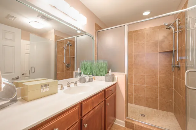 a bathroom with a double vanity sink mirror double and shower