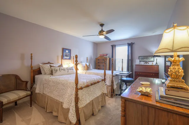 a bed room with a bed mirror and a desk