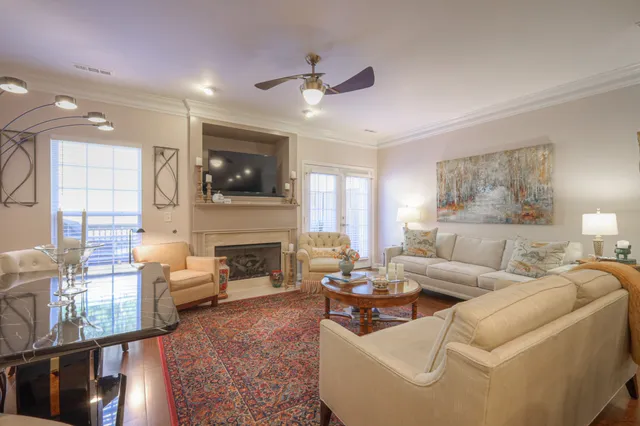 a living room with fireplace furniture and a flat screen tv