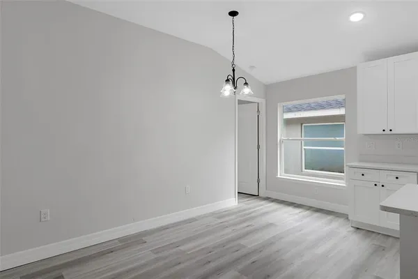 a view of a room with wooden floor