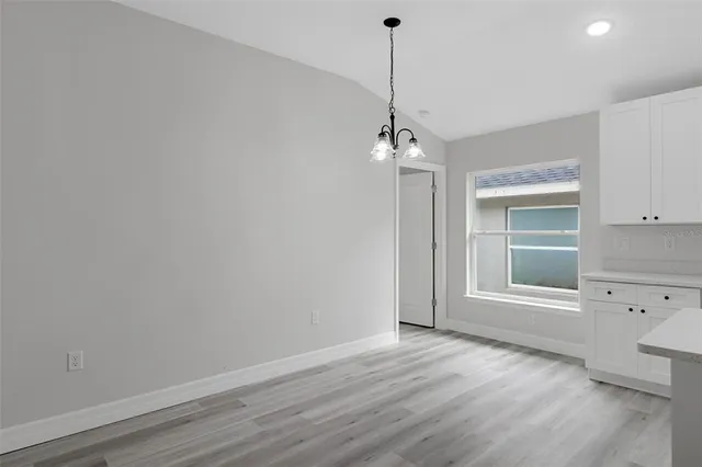 a view of a room with wooden floor