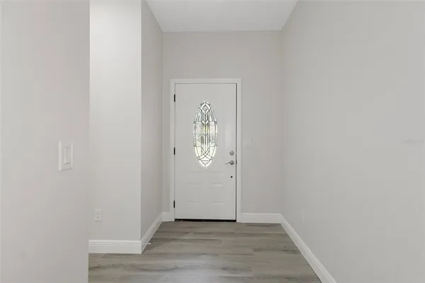 a view of an entryway with wooden floor