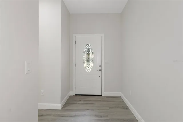 a view of an entryway with wooden floor