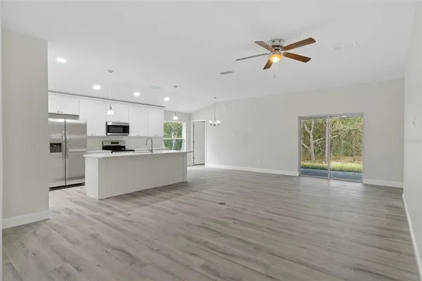 a view of kitchen with cabinets and wooden floor