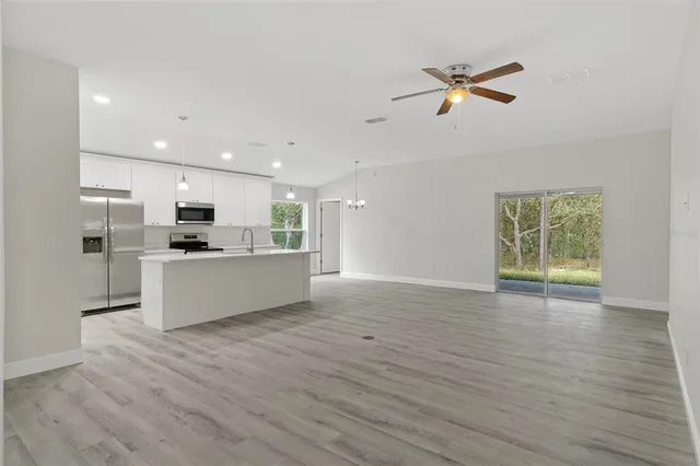 a view of kitchen with cabinets and wooden floor