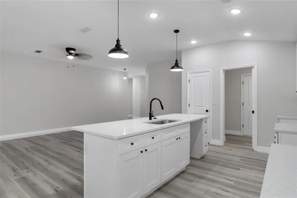 a spacious bathroom with a double vanity sink and a mirror