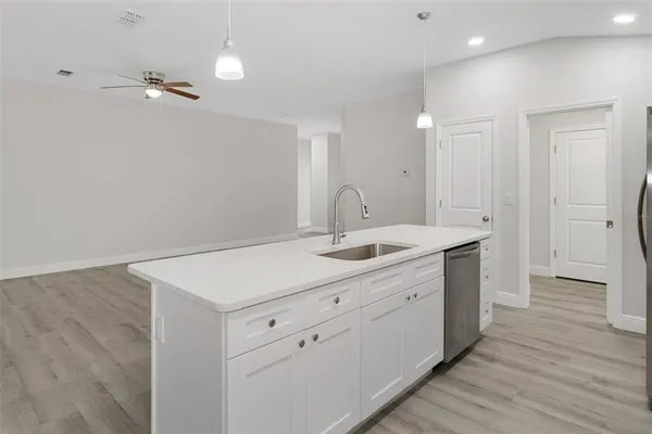 a view of a bathroom with a sink mirror and shower