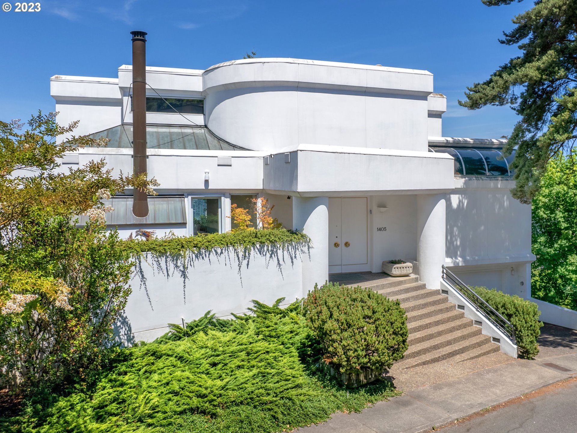 a front view of a house with a garden