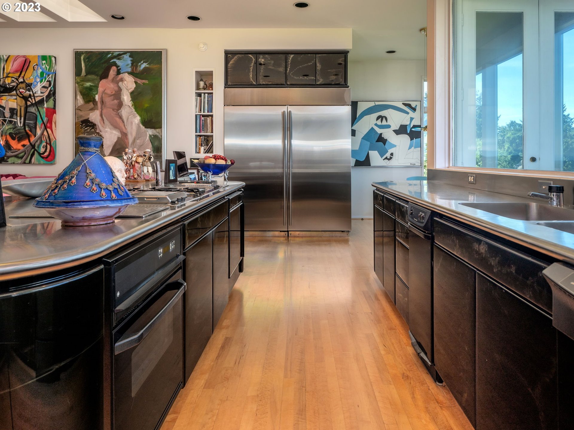 1405 Southwest Cardinell Drive Portland, OR 97201 - Photo 13 of 36 a kitchen with kitchen island granite countertop a sink appliances and cabinets