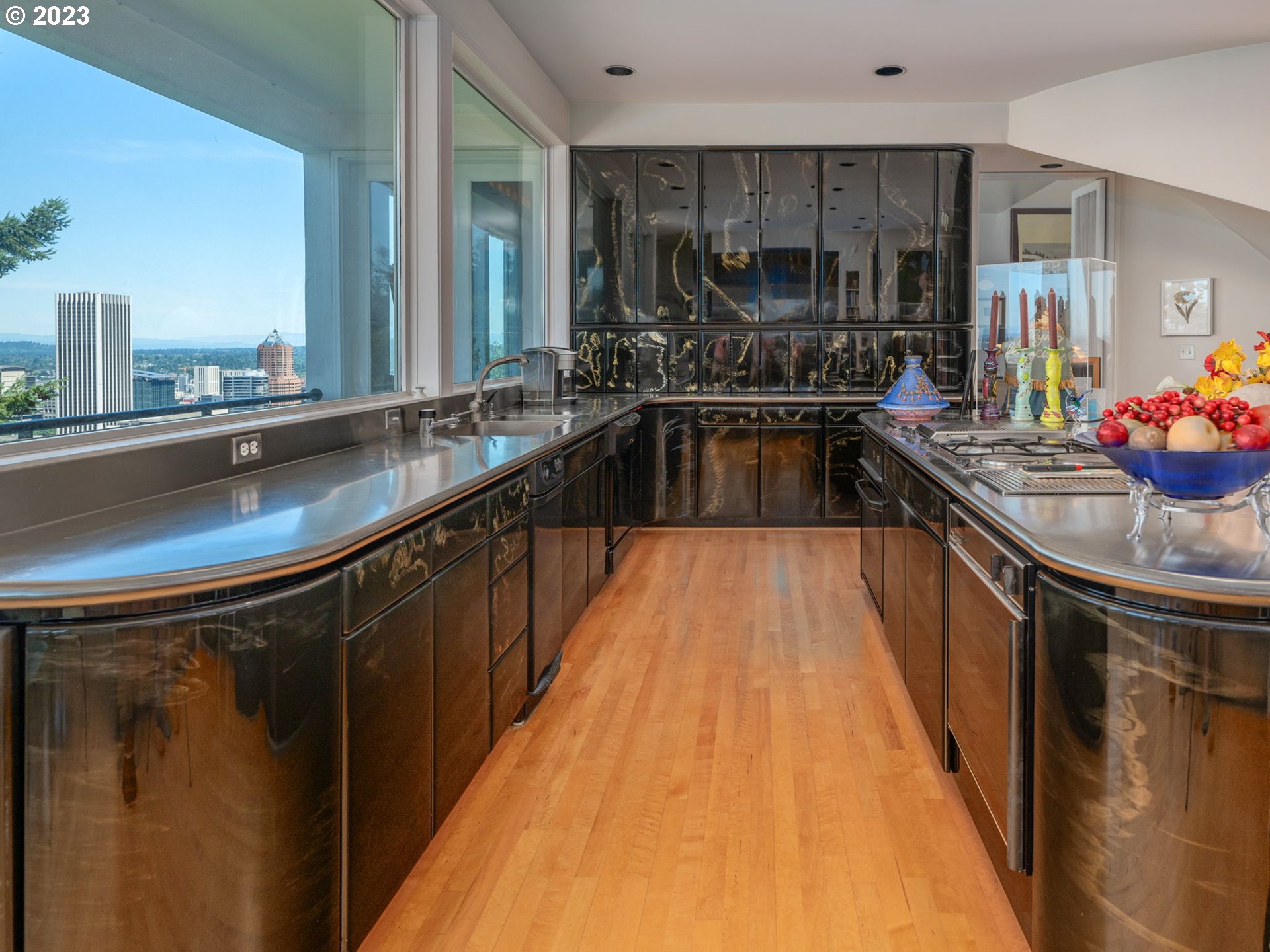 1405 Southwest Cardinell Drive Portland, OR 97201 - Photo 14 of 36 a kitchen with kitchen island granite countertop a sink and a stove