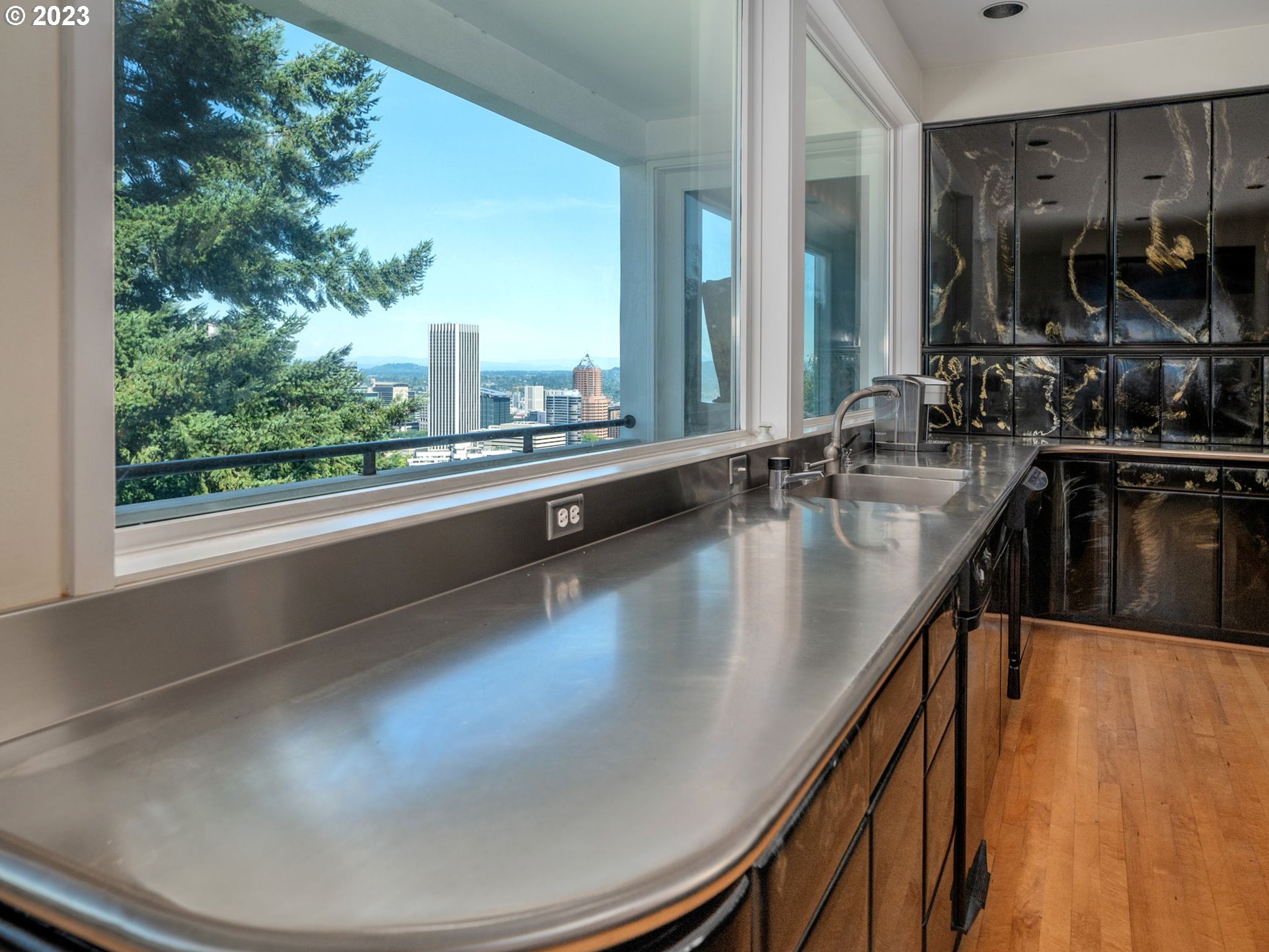 1405 Southwest Cardinell Drive Portland, OR 97201 - Photo 15 of 36 a kitchen with kitchen island a large window appliances and cabinets