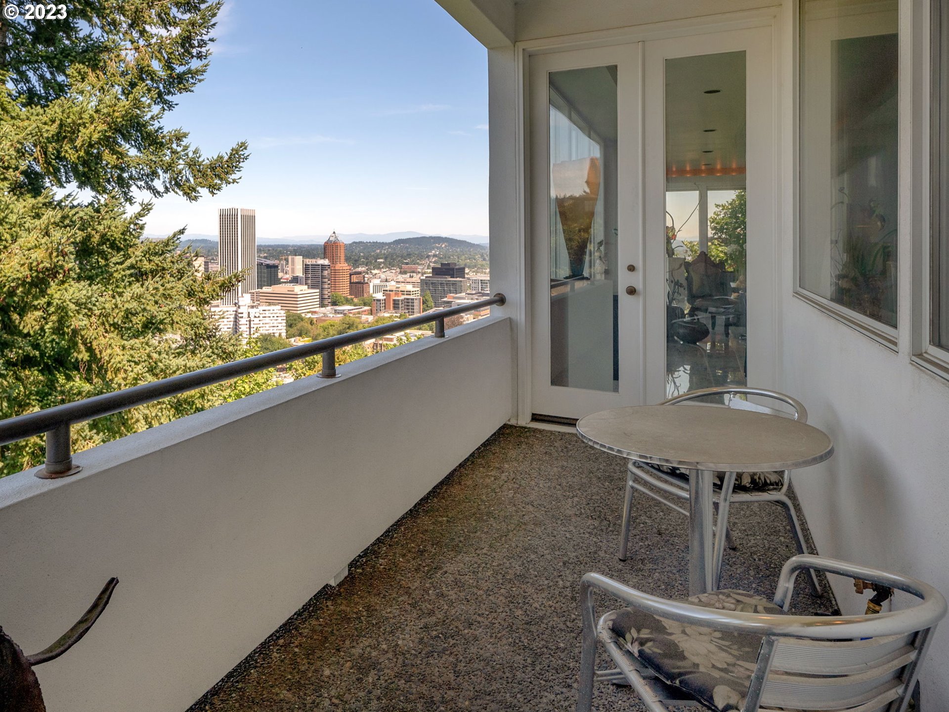 1405 Southwest Cardinell Drive Portland, OR 97201 - Photo 10 of 36 a porch with a table and chairs