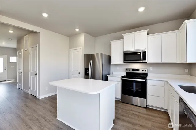 a kitchen with stainless steel appliances a refrigerator stove microwave and sink