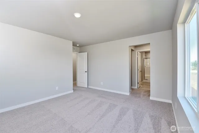 a spacious bathroom with a shower sink and mirror