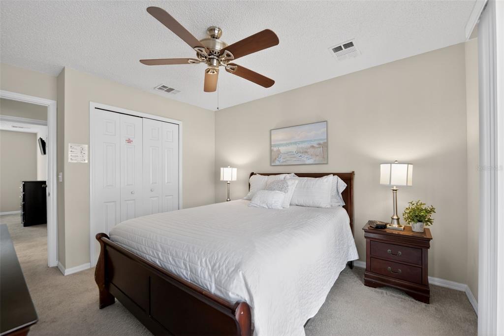 8538 Crystal Cove Loop Kissimmee, FL 34747 - Photo 17 of 59 a bedroom with a bed and a chandelier