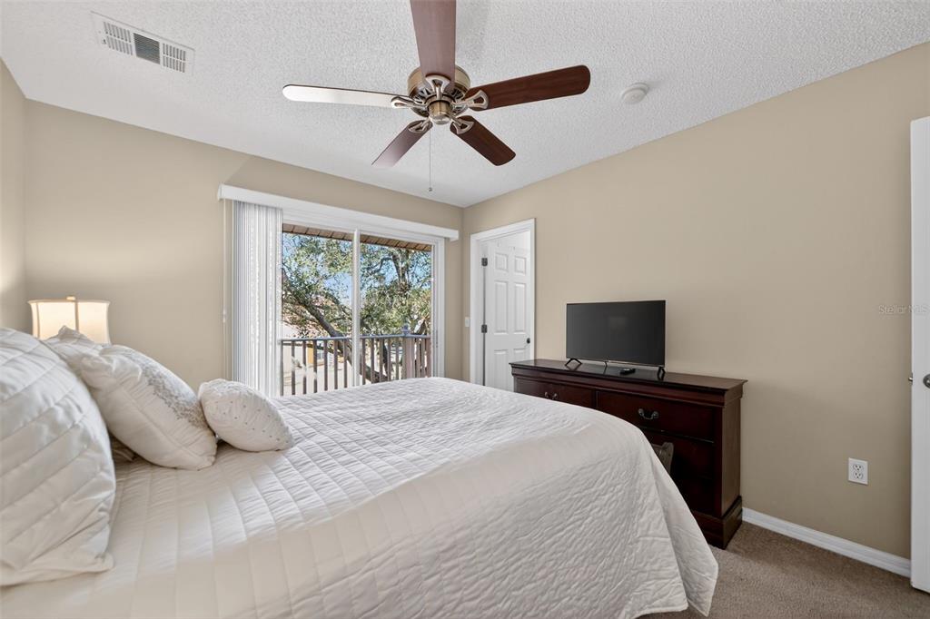 8538 Crystal Cove Loop Kissimmee, FL 34747 - Photo 19 of 59 a bedroom with a bed and a flat tv screen