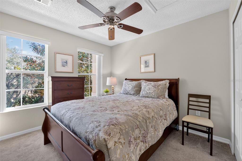 8538 Crystal Cove Loop Kissimmee, FL 34747 - Photo 24 of 59 a bed sitting in a bedroom next to a window