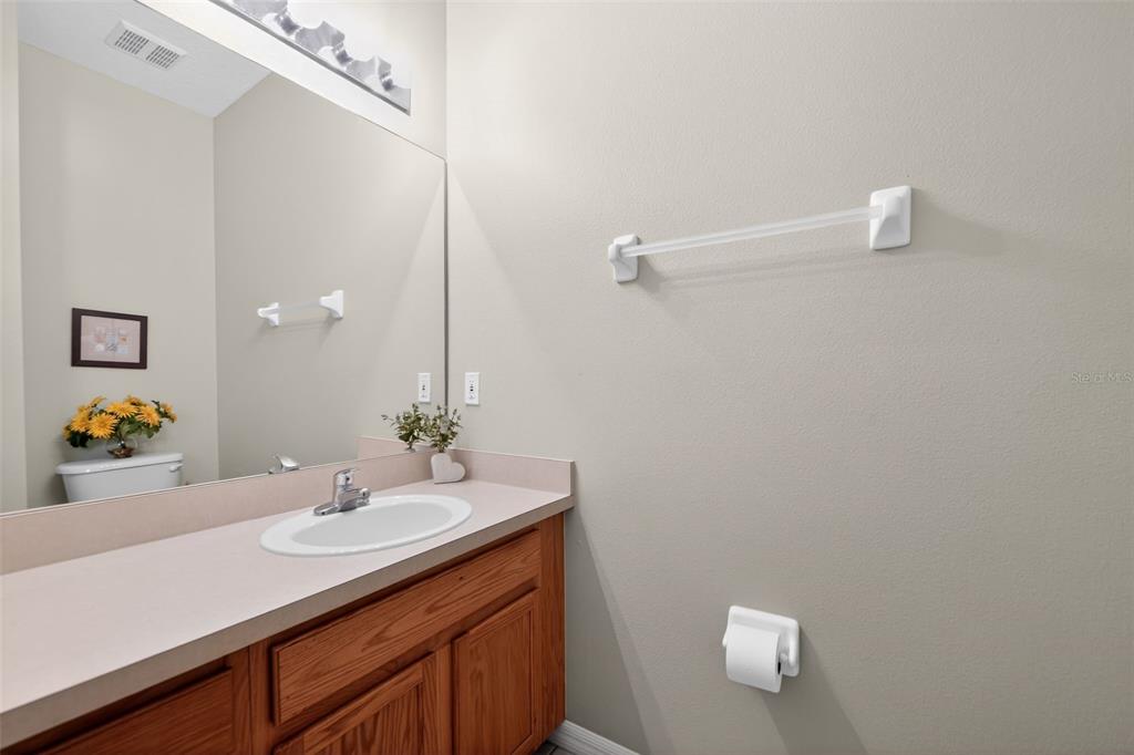 8538 Crystal Cove Loop Kissimmee, FL 34747 - Photo 27 of 59 a bathroom with a sink vanity and mirror