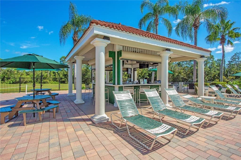 8538 Crystal Cove Loop Kissimmee, FL 34747 - Photo 39 of 59 a view of a patio with a dining table and chairs under an umbrella with a patio