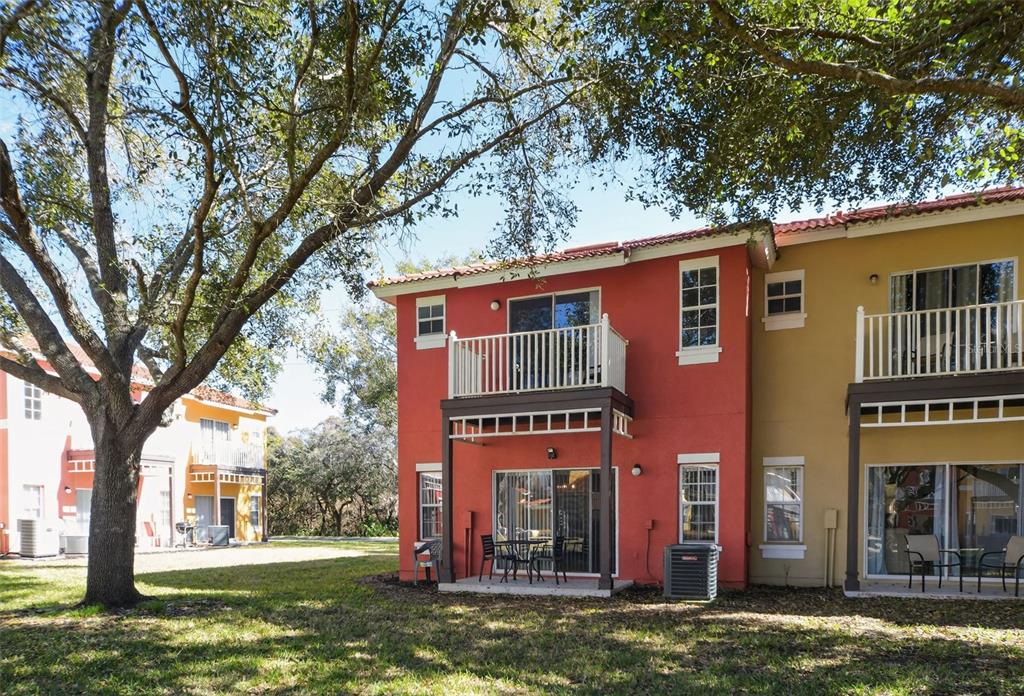8538 Crystal Cove Loop Kissimmee, FL 34747 - Photo 6 of 59 a building view with a large tree in front of it