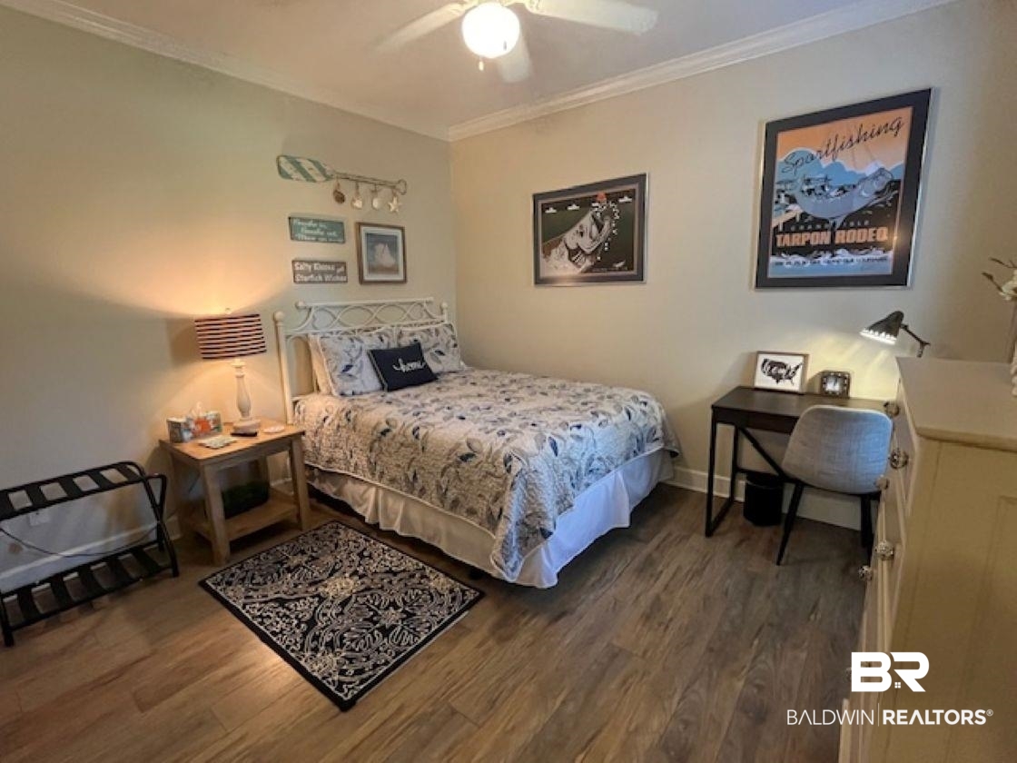 450 Park Avenue, Unit 112 Foley, AL 36535 - Photo 12 of 20 Bedroom featuring wood finished floors, crown molding, baseboards, and ceiling fan