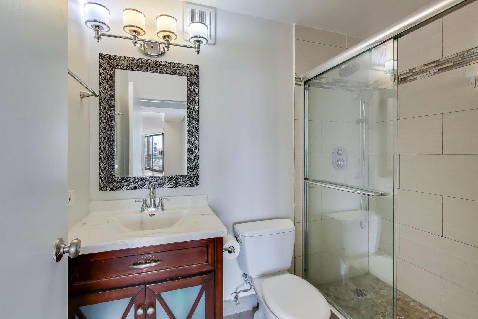 33 West Delaware Place, Unit 12K Chicago, IL 60610 - Photo 11 of 21 a bathroom with a toilet a sink and shower