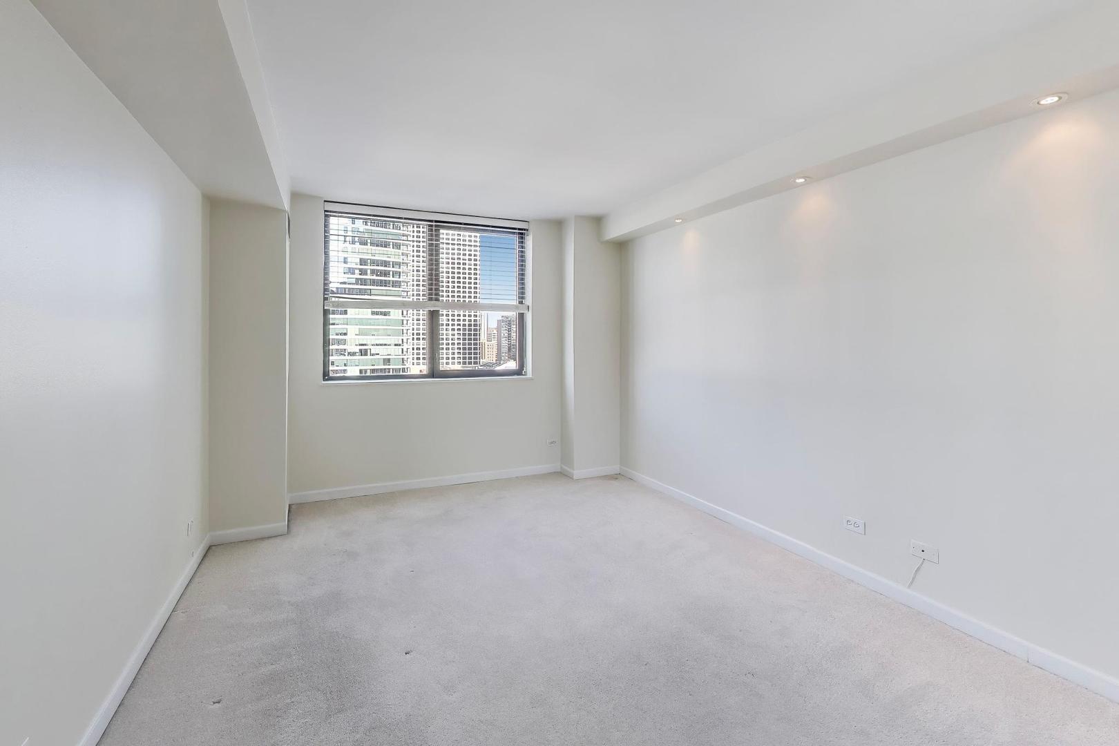 33 West Delaware Place, Unit 12K Chicago, IL 60610 - Photo 12 of 21 a view of an empty room with a window