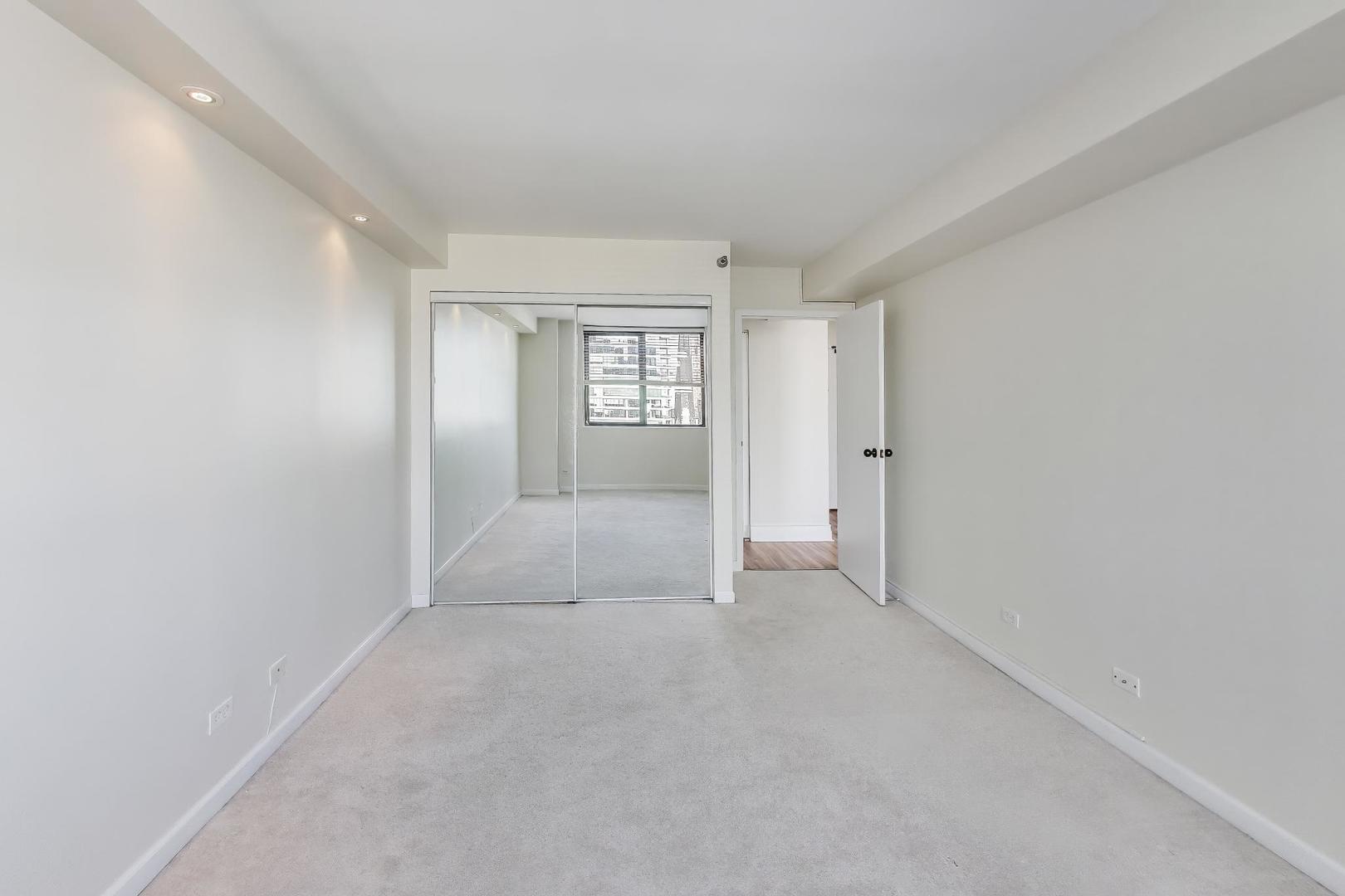 33 West Delaware Place, Unit 12K Chicago, IL 60610 - Photo 13 of 21 wooden floor in an empty room with a window
