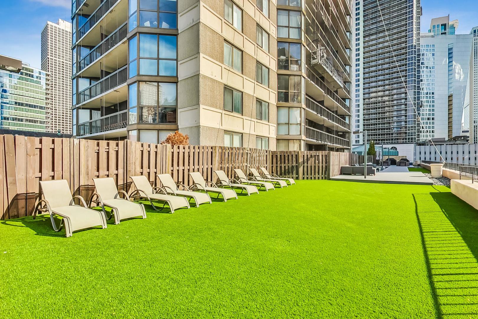 33 West Delaware Place, Unit 12K Chicago, IL 60610 - Photo 16 of 21 a view of a swimming pool with chairs