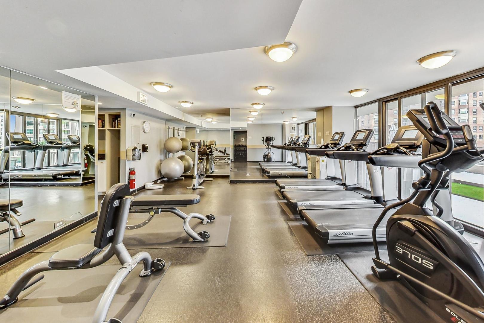 33 West Delaware Place, Unit 12K Chicago, IL 60610 - Photo 17 of 21 a view of a room with gym equipment