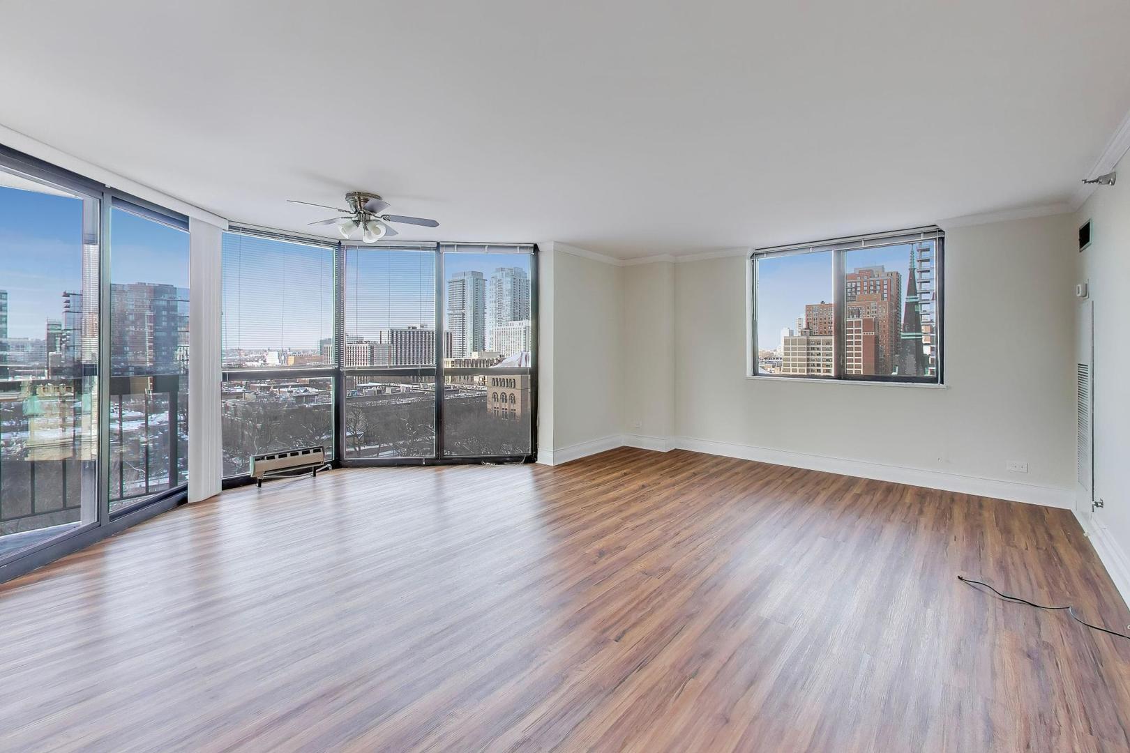 33 West Delaware Place, Unit 12K Chicago, IL 60610 - Photo 5 of 21 a view of a room with wooden floor and windows