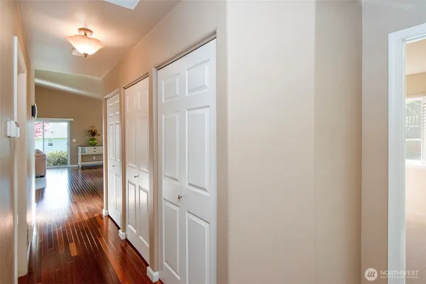 a view of a hallway with wooden floor