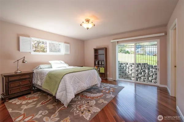 a bedroom with a large bed and a chandelier