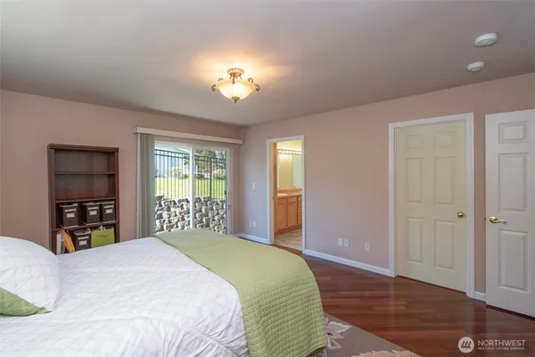 a bedroom with a large bed and a window